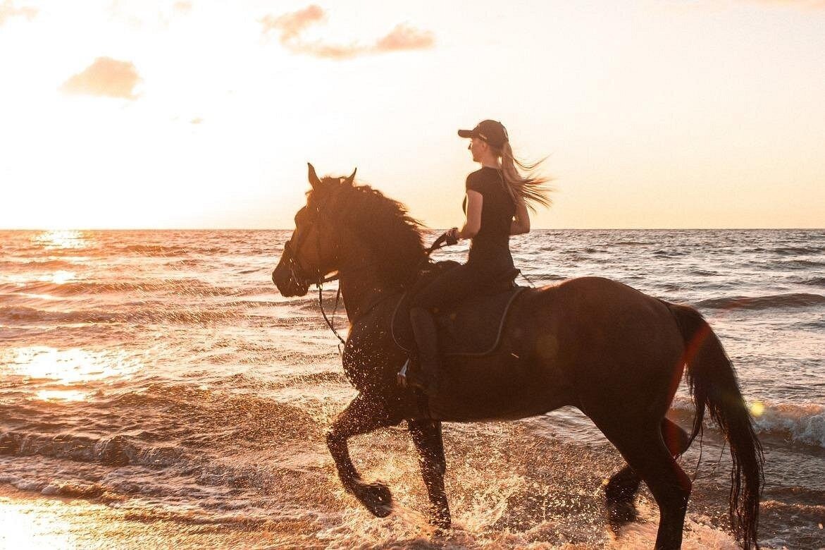 Horse riding on Gili Air beach at sunset